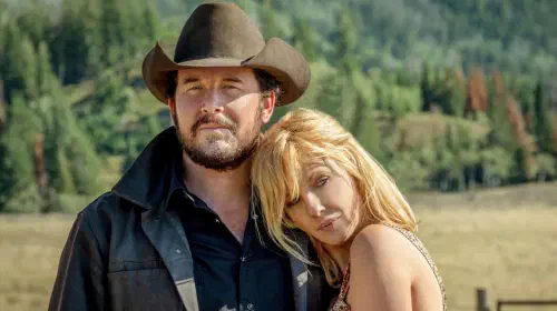 assets/cole-hauser-as-rip-wheeler-standing-with-kelly-reilly-as-beth-dutton-leaning-on-his-shoulder-in-yellowstone-season-3.jpeg