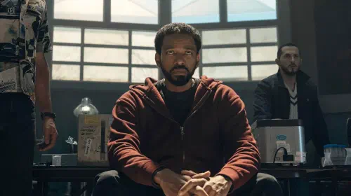 assets/laz-alonso-as-mm-in-the-boys-sitting-down-looking-miserable-in-the-boys-season-5.jpeg