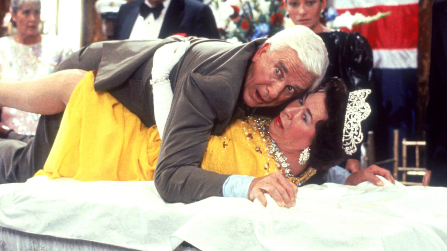 leslie-nielsen-s-frank-looking-shocked-while-laying-on-top-of-jeanette-charles-queen-elizabeth-ii-in-the-naked-gun.jpeg