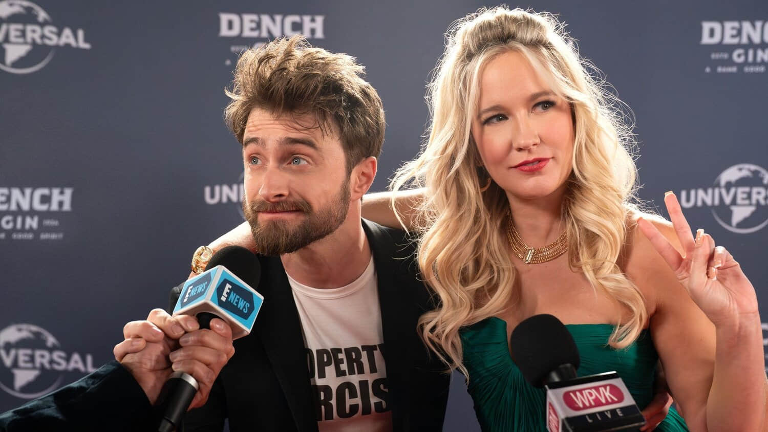 daniel-radcliffe-looking-dazed-while-talking-into-a-microphone-on-the-red-carpet-in-the-fall-and-rise-of-reggie-dinkins.jpeg