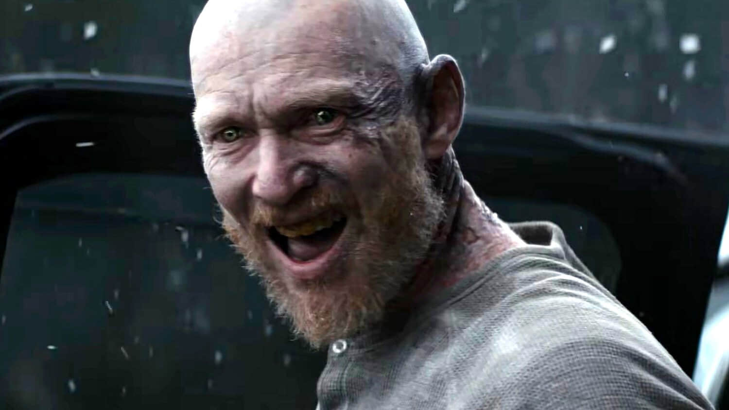 a-deadite-smiling-creepily-toward-the-camera-in-evil-dead-burn.jpeg