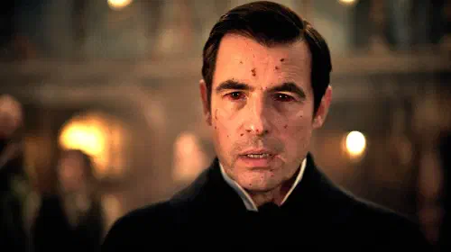assets/claes-bang-s-dracula-looking-in-thought-with-blood-on-his-face-and-in-his-eyes.jpeg