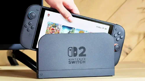assets/nintendo-switch-2-being-loaded-into-a-dock-with-the-home-screen-visible-as-it-s-being-placed-inside-the-dock-by-a-person-s-hand.jpeg
