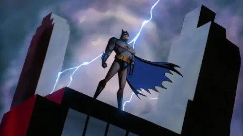assets/batman-the-animated-series-intro-image-of-batman-standing-on-a-rooftop-with-lightning-behind-him.jpeg