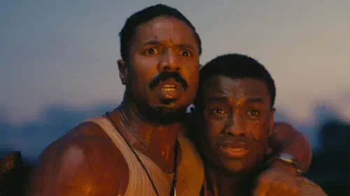 assets/michael-b-jordan-as-the-smoke-with-miles-caton-as-samuel-sammie-in-sinners.jpeg