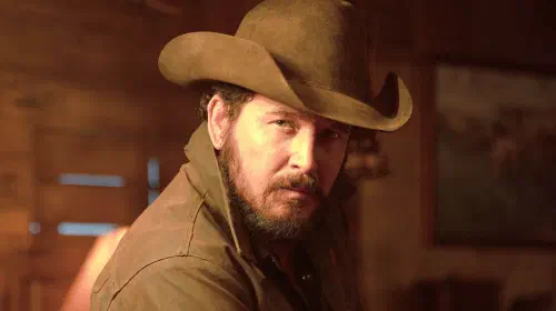 assets/cole-hauser-s-rip-looking-intimidatingly-over-his-shoulder-in-dutton-ranch.jpeg