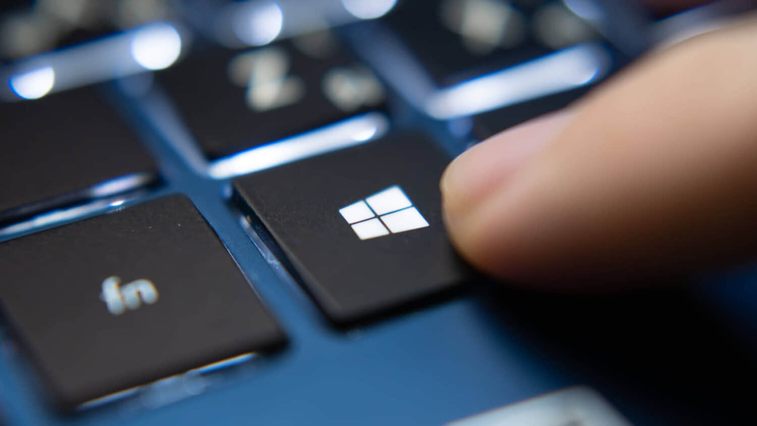 Finger-pressing-Windows-key-on-a-blue-laptop-keyboard-1.jpeg