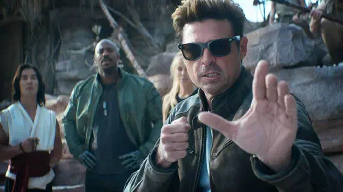 assets/karl-uban-s-johnny-cage-looking-stern-in-a-fight-pose-with-ludi-lin-s-liu-kang-mehcad-brooks-jax-and-jessica-mcnamee-s-sonya-behind-him-in-mortal-kombat-ii.jpg