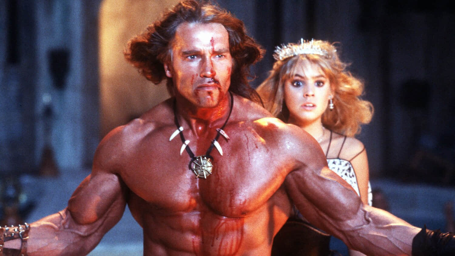 arnold-schwarzenegger-s-conan-looking-bloodied-and-serious-standing-in-front-of-olivia-d-abo-s-princess-jehnna-in-conan-the-destroyer.jpeg