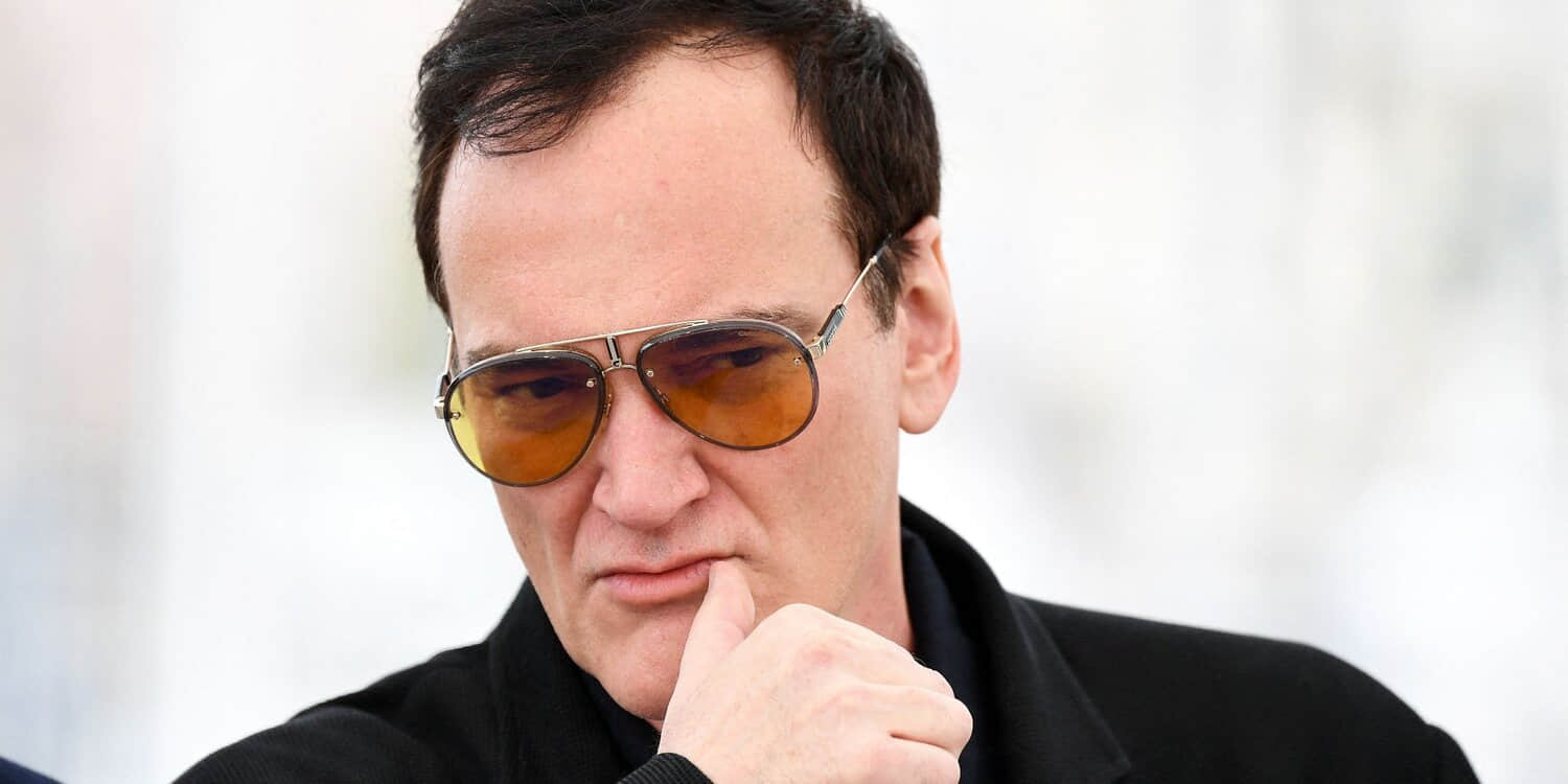 quentin-tarantino-peers-forward-intently-while-attending-an-event.jpeg