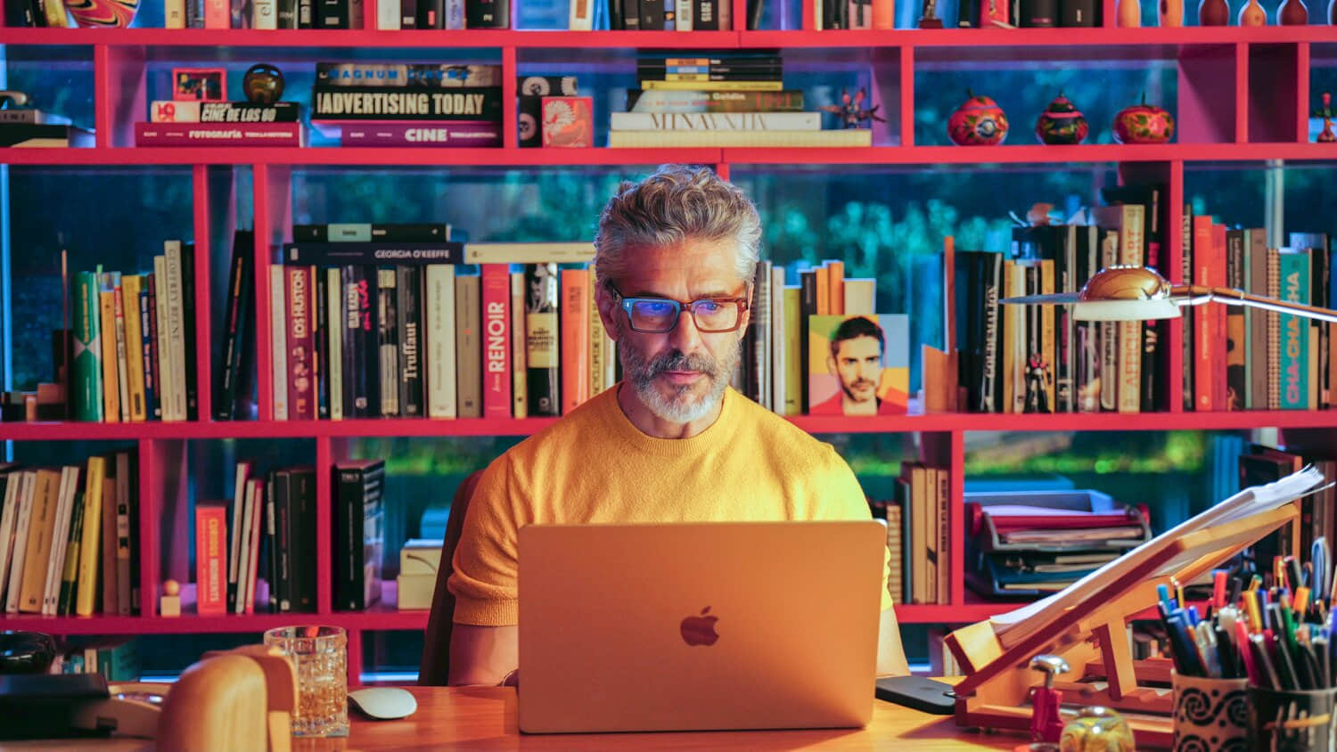 ra-l-at-his-computer-in-front-of-a-bookshelf-in-bitter-christmas.jpeg