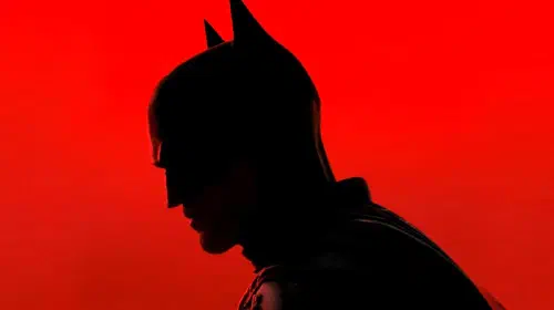 assets/robert-pattinson-s-dark-knight-stands-in-front-of-a-red-background-in-the-batman.jpeg