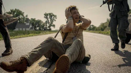 assets/a-young-man-in-panic-sitting-in-the-middle-of-the-road-in-the-long-walk.jpeg