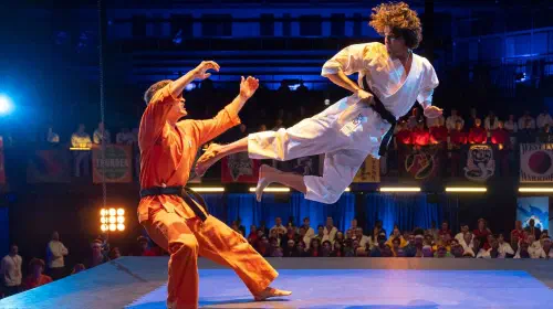 assets/miguel-performs-a-flying-kick-in-cobra-kai.jpeg