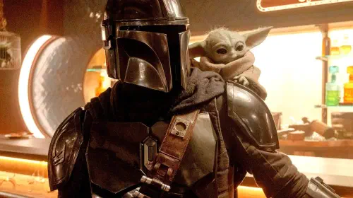assets/mando-at-a-bar-with-grogu-on-his-shoulder-in-the-mandalorian-and-grogu.jpeg