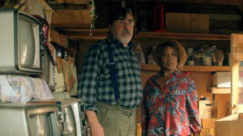 assets/alfred-molina-as-sam-cooper-and-alfre-woodard-as-judy-daniels-standing-in-a-garage-in-the-boroughs.jpeg