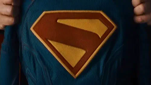 assets/david-corenswet-as-superman-holding-up-supergirl-suit.jpeg