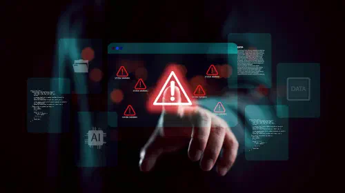 assets/Security-warning-alert-with-shadowy-scammer-hacker-in-darkness-1.jpeg