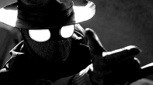 assets/nicolas-cage-as-spider-man-noir-with-his-hand-reached-out-in-spider-noir.jpeg