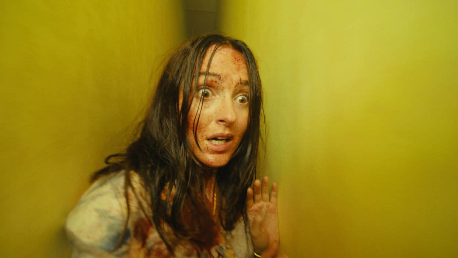 renate-reinsve-running-through-a-tight-hallway-with-blood-on-her-face-in-backrooms.jpeg