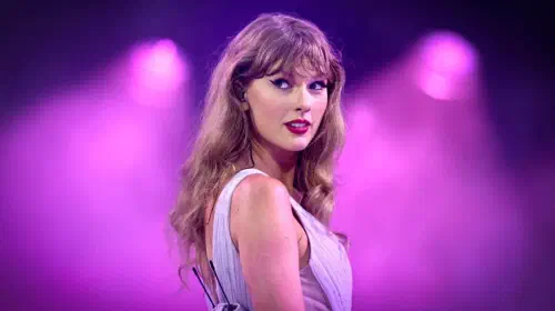 assets/taylor-swift-in-front-of-purple-flood-lights.jpeg