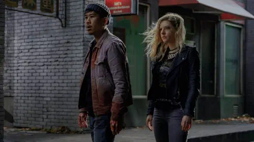 assets/two-characters-stand-in-the-street-in-wu-assassins.jpeg