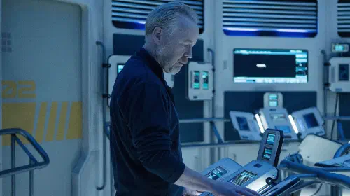assets/a-man-stands-at-a-spacecraft-console-in-the-expanse.jpeg