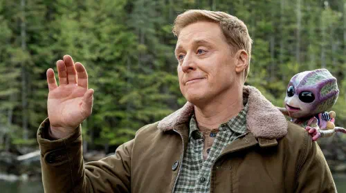 assets/harry-waving-in-resident-alien.jpeg