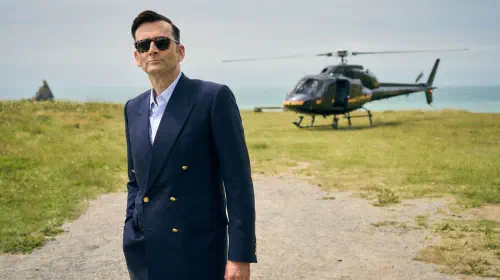 assets/david-tennant-with-a-helicopter-in-the-background-in-rivals-season-2-episode-1.jpeg