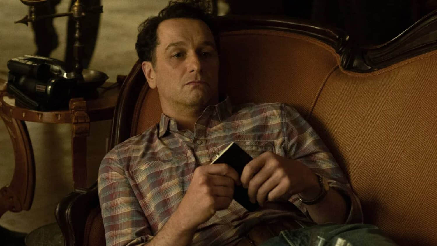 matthew-rhys-lies-on-a-sofa-in-widow-s-bay.jpeg