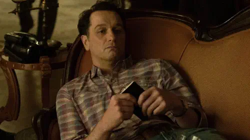 assets/matthew-rhys-lies-on-a-sofa-in-widow-s-bay.jpeg