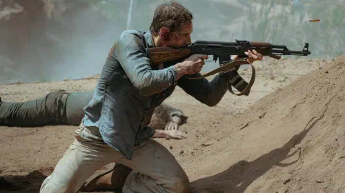assets/michael-fassbender-as-martian-firing-a-gun-in-the-agency-season-2.jpeg