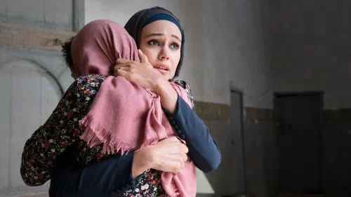 assets/dina-shihabi-hugging-someone-on-jack-ryan-season-1.jpeg
