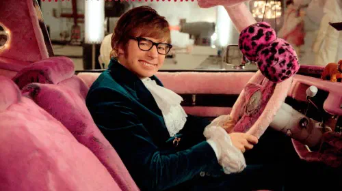 assets/mike-myers-as-austin-powers-in-a-pink-velvet-car-smiling-in-goldmember.jpeg