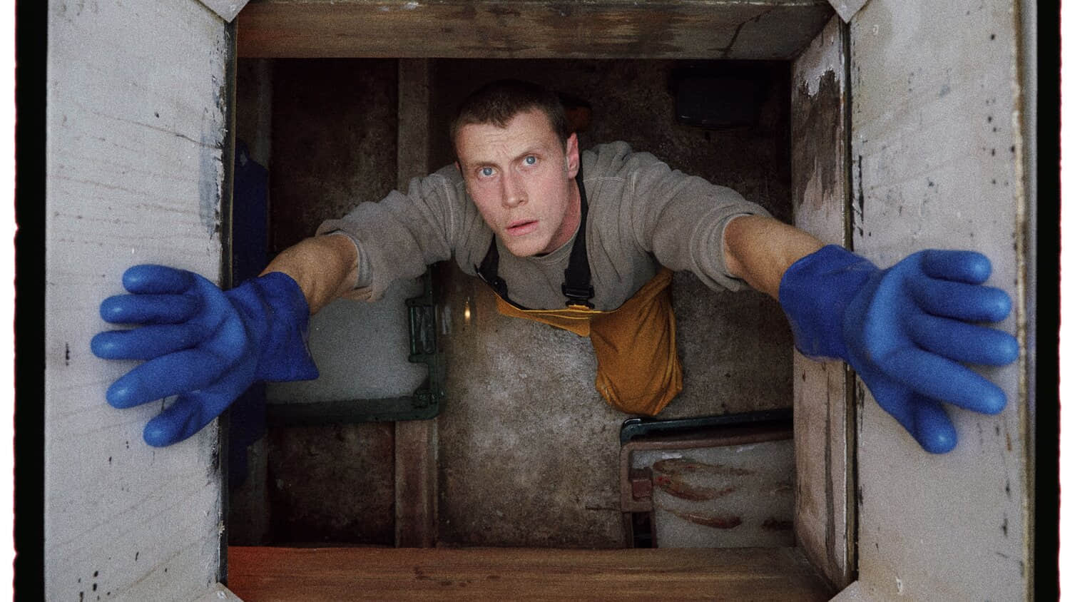 george-mackay-staring-up-from-inside-the-fishing-boat-in-rose-of-nevada.jpeg