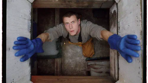 assets/george-mackay-staring-up-from-inside-the-fishing-boat-in-rose-of-nevada.jpeg