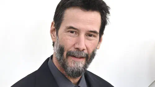 assets/keanu-reeves-posing-on-a-red-carpet.jpeg
