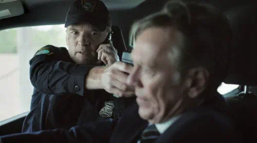 assets/joel-edgerton-holds-a-gun-to-a-man-s-head-in-i-will-find-you-2026.jpeg