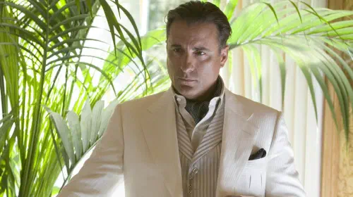 assets/andy-garcia-in-a-white-suit-next-to-a-plant-in-oceans.jpeg