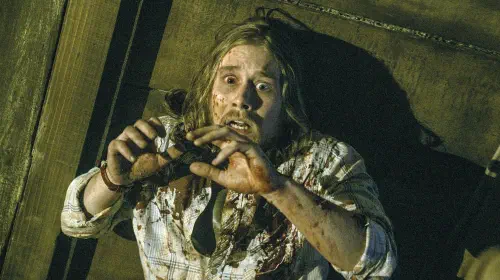 assets/lou-taylor-pucci-cringes-in-horror-in-evil-dead-2013.jpeg