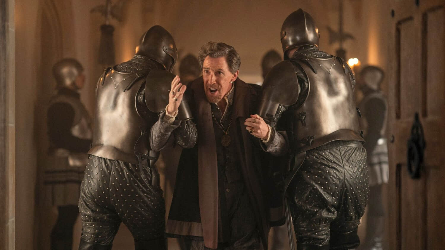 rob-brydon-as-lord-dudley-being-dragged-away-by-two-soldiers-in-my-lady-jane.jpeg
