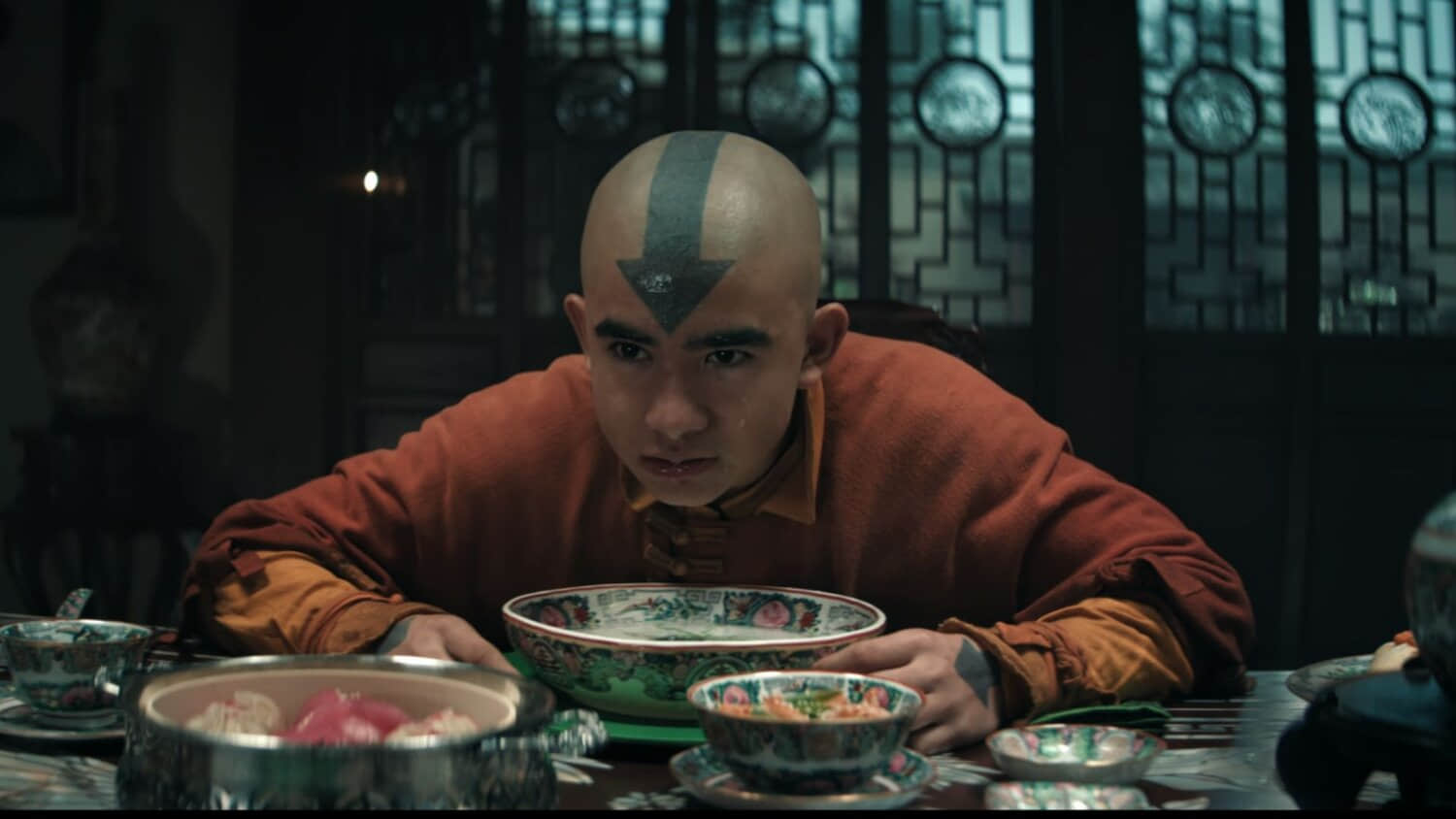 aang-looking-up-from-his-soup-at-toph-in-netflix-s-avatar-the-last-airbender.jpeg