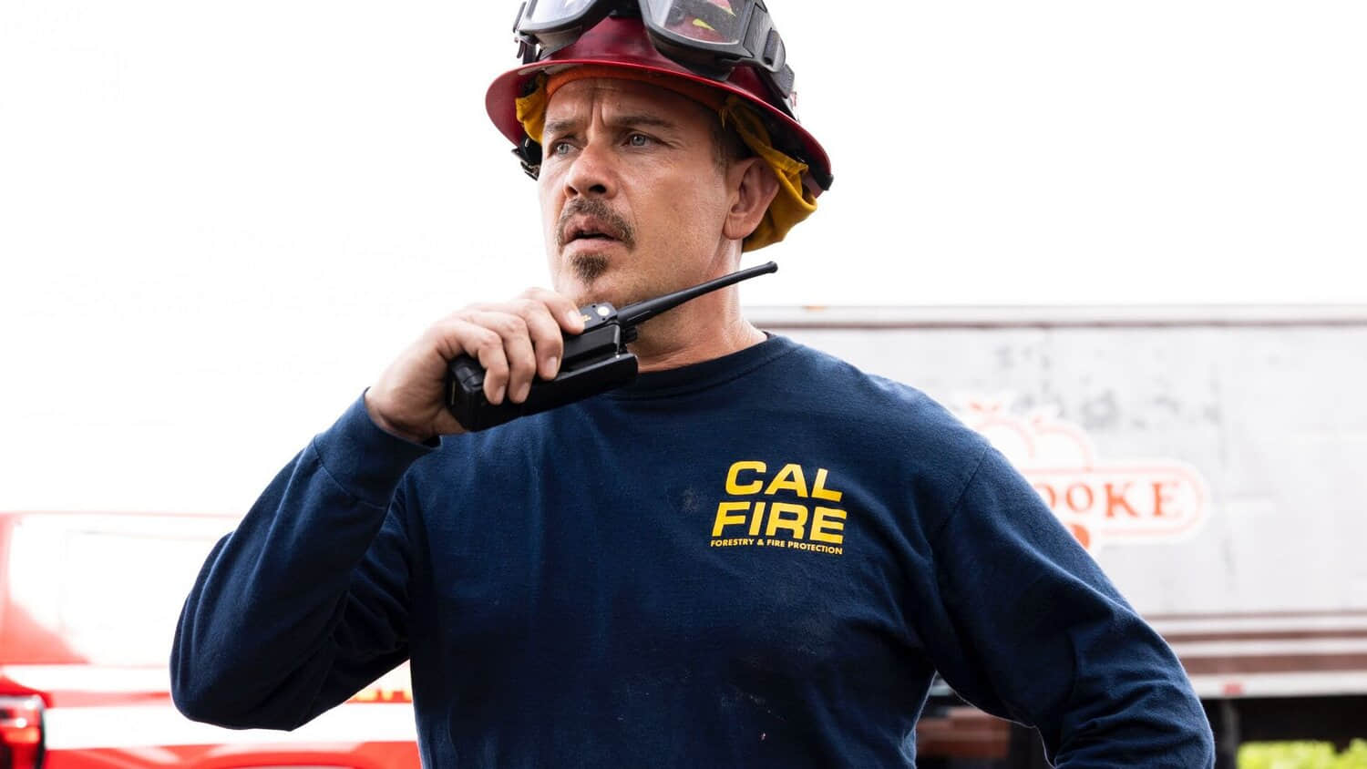 kevin-alejandro-holding-a-walkie-talkie-and-looking-confused-in-fire-country.jpeg