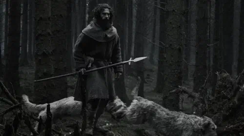 assets/aaron-taylor-johnson-standing-on-a-fallen-tree-in-werwulf.jpeg