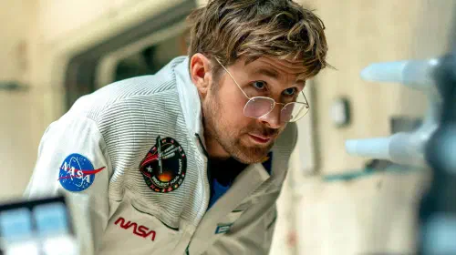 assets/ryan-gosling-as-ryland-grace-leaning-forward-in-project-hail-mary.jpeg