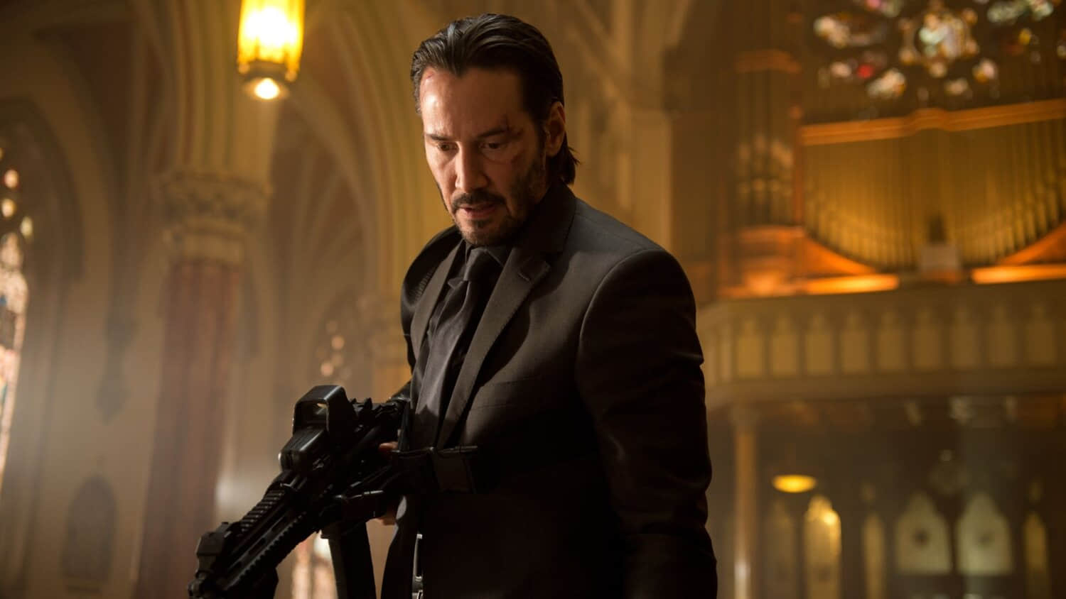 keanu-reeves-as-john-wick-holding-a-gun-and-looking-down-in-john-wick.jpeg