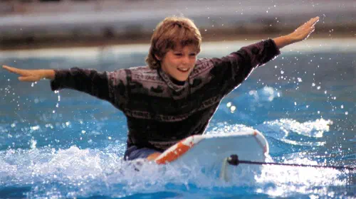 assets/jesse-with-his-arms-spread-on-a-boogey-board-in-free-willy.jpeg