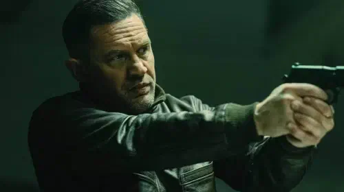 assets/tom-hardy-as-harry-da-souza-holding-a-gun-in-mobland.jpeg