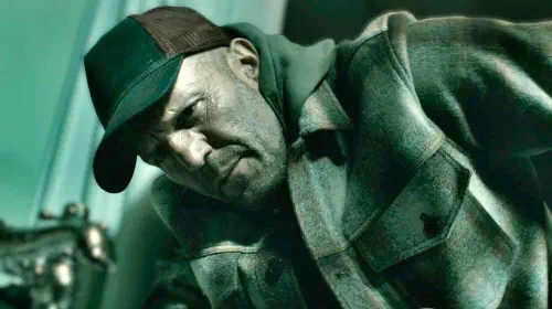assets/statham-wearing-a-hat-in-a-working-man.jpeg