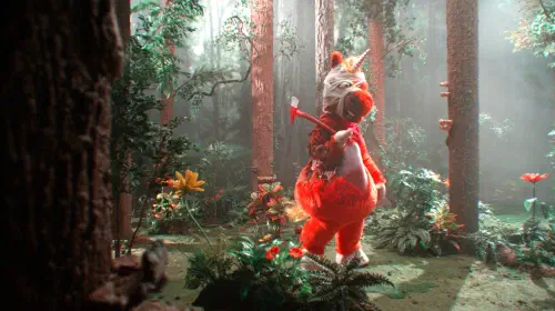 assets/buddy-standing-in-the-forest-while-holding-an-axe-in-buddy.jpeg